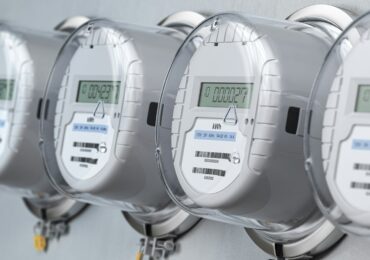 Digital electric meters in a row measuring power use. Electricity consumption concept.